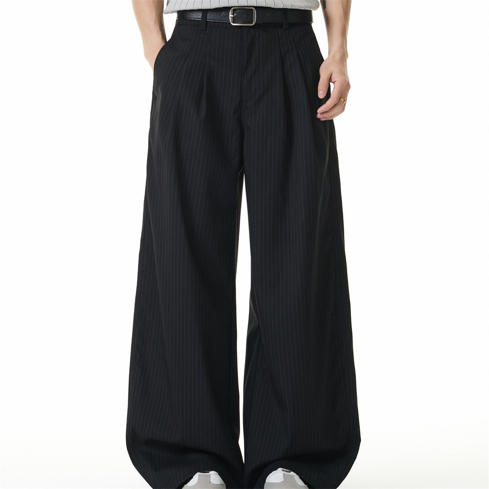 Men's black pinstripe wide-leg double-pleat trousers with floor-length drape, front and back view