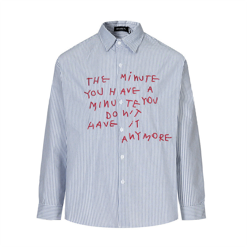 Men's oversized blue pinstripe long sleeve button-up shirt with red hand-lettered embroidery on the chest