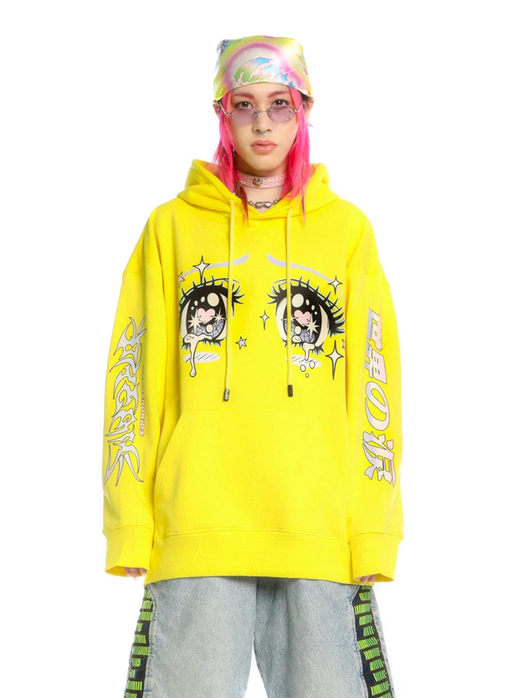 A person flaunting streetwear style in Seakoff's Kawaii Aesthetic Crying Eyes Hoodie—a pastel and dark anime pullover featuring cartoon eyes and Japanese sleeve graphics—complements their pink hair with a colorful headscarf, sunglasses, a choker, and loose-fitting jeans.