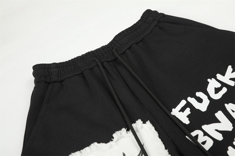 Pantalon de survêtement homme à jambes larges, motif graphique – Écusson licorne et slogan imprimé noir