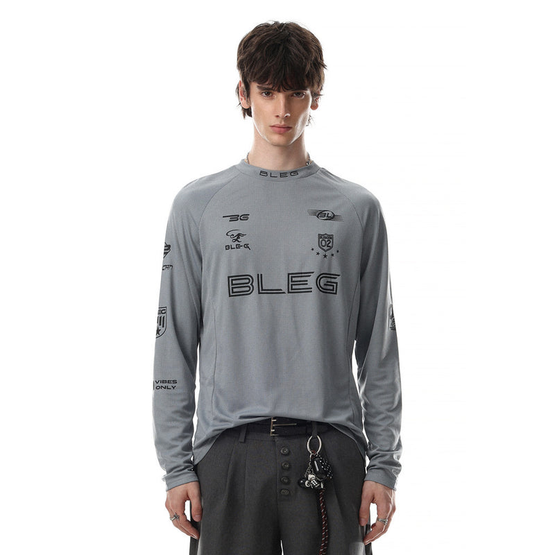 Front view of gray long sleeve crew neck shirt with black racing-style logo prints