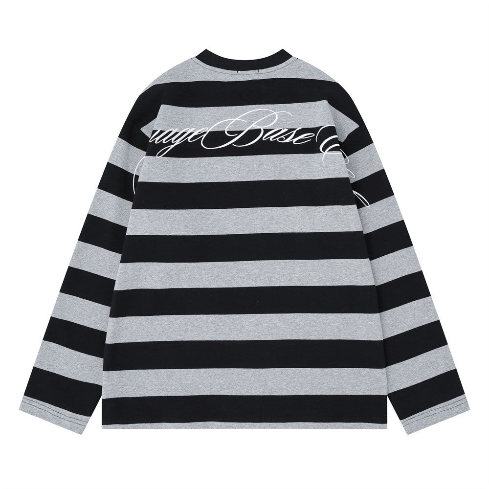 Back view of black and gray striped long sleeve shirt with large cursive graphic across the shoulders