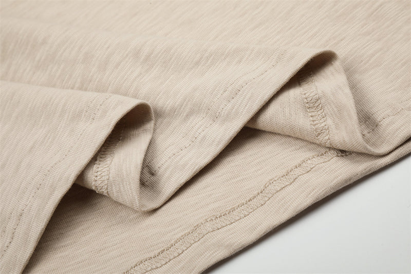 Close-up of beige long sleeve tee hem and seam stitching