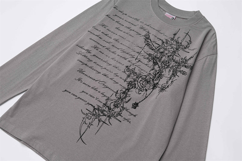 Gray long sleeve T-shirt laid flat with gothic cross and script print on front