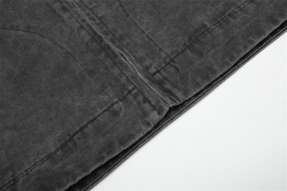 Close-up of black jacket hem seam and stitching detail