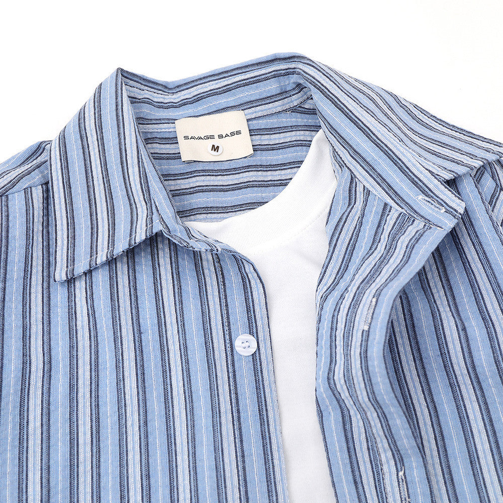 Blue striped shirt collar and top front close-up with label and layered neckline