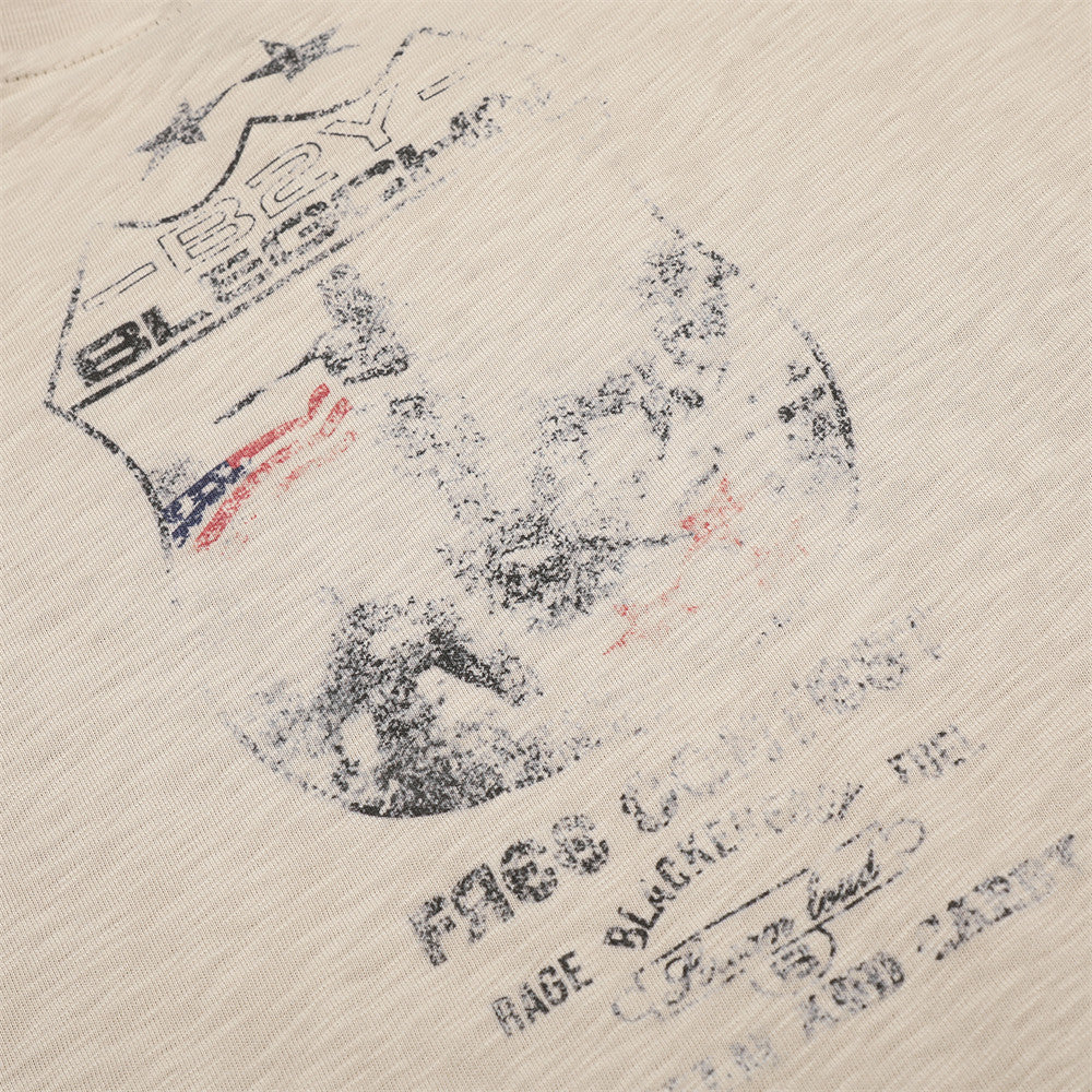 Close-up of faded front graphic print on beige long sleeve tee