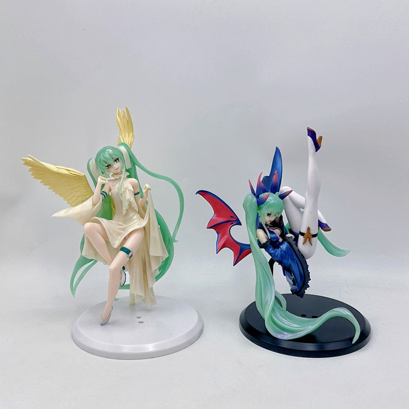 The Hatsune Miku Light &amp; Dark 17cm PVC Figures feature anime-style designs of an angel with green hair and yellow wings in a flowing outfit, and a demon with bat-like wings suspended upside-down in a dark ensemble with blue and red accents.