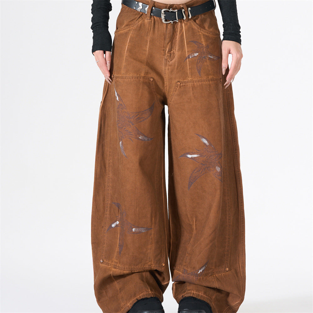 Baggy wide-leg cargo pants in washed brown with all-over swallow bird graphic print and copper rivet detailing