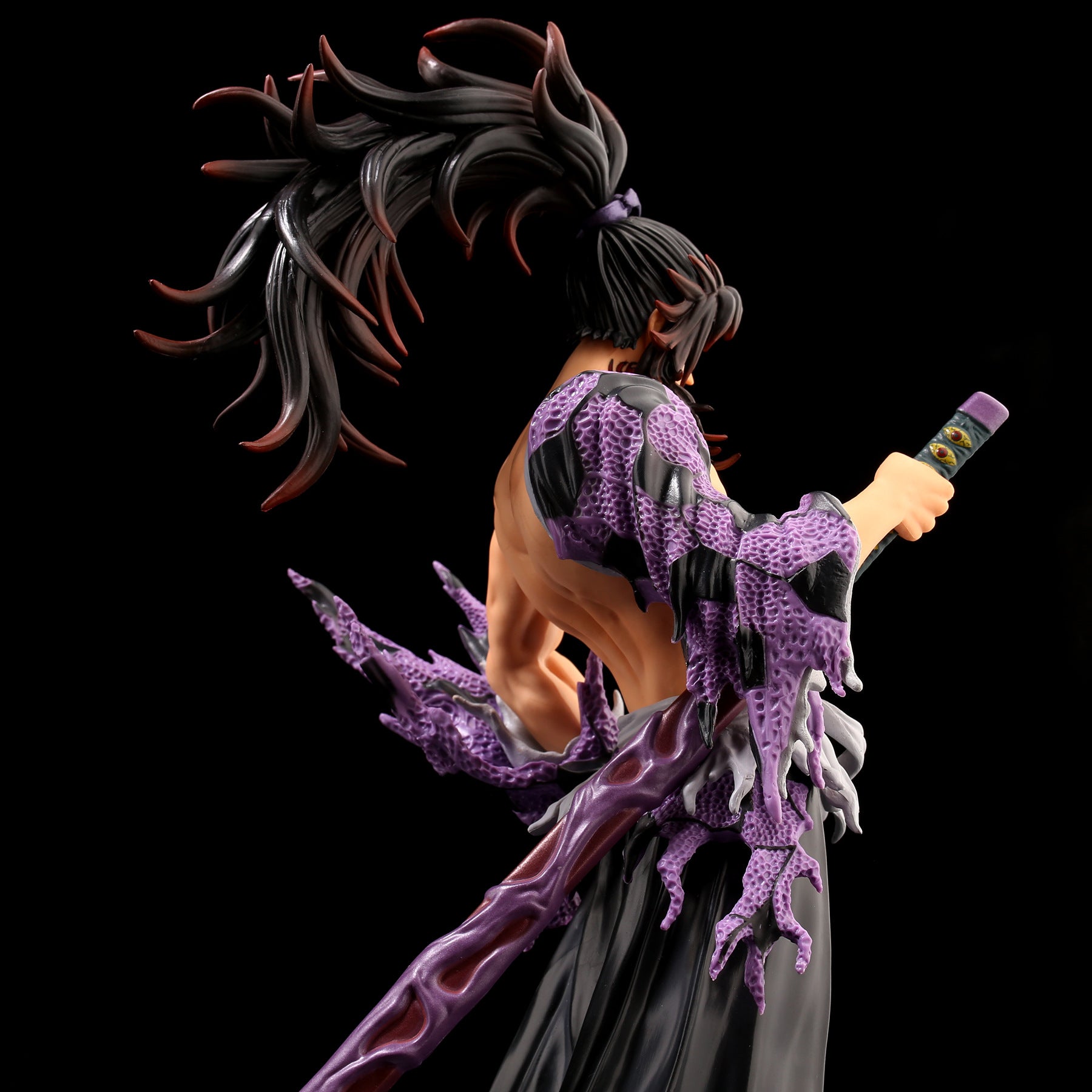 The 31CM Kokushibo Demon Slayer PVC Action Figure features a character with long black hair and a decorated sword, wearing a purple textured garment resembling scales or armor. It&