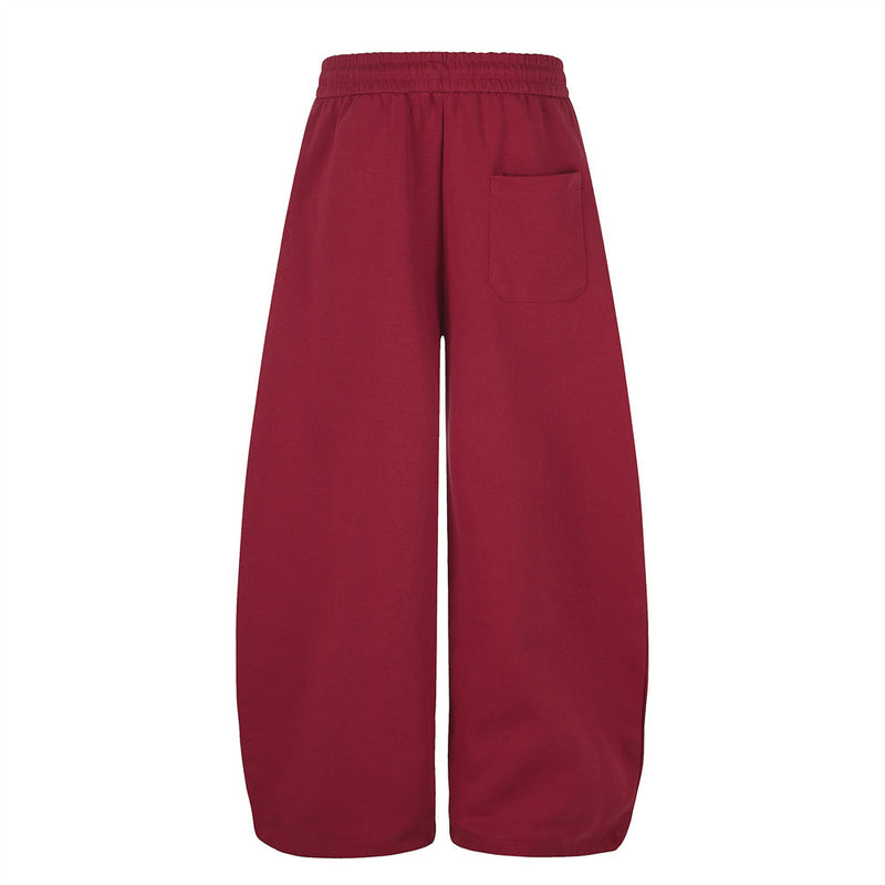 Pantalon de jogging large – Motif patte et coutures courbes rouges