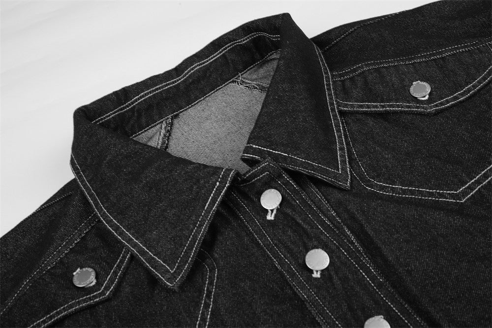 Close-up of black denim jacket collar and front snap buttons with contrast stitching