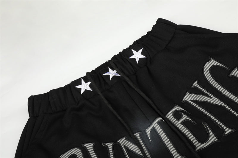 Pantalones de chándal holgados de pernera ancha con lavado efecto spray y gráfico de letras