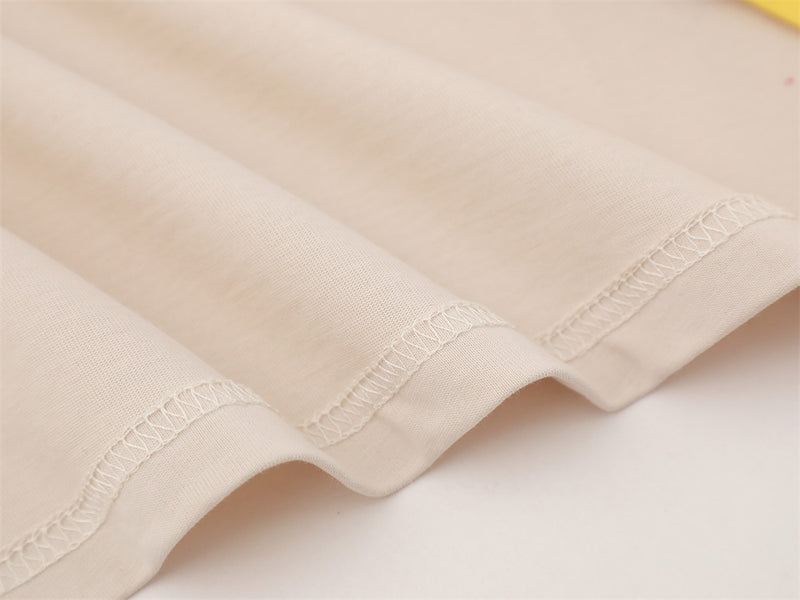Close-up of cream fabric hem with neat overlock stitching