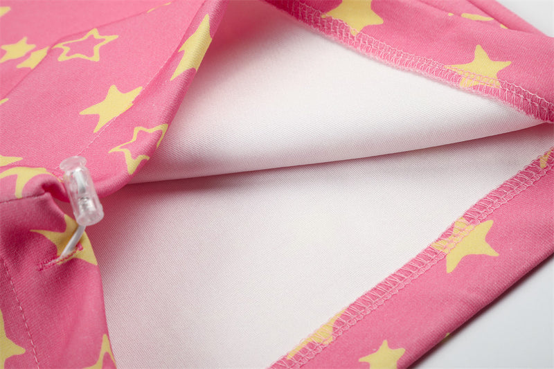 Close-up of pink star print sweatpants inside seams and white lining