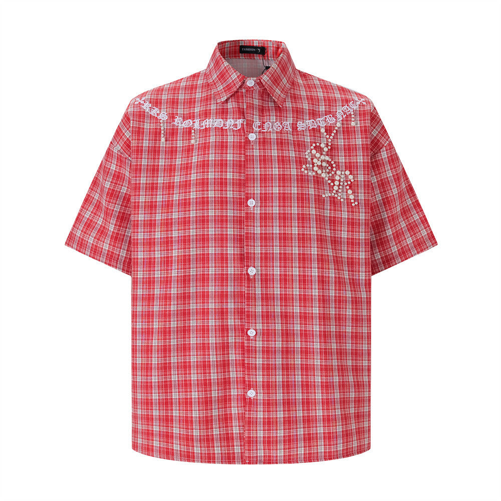 Oversized red plaid short-sleeve shirt with pearl star embroidery and gothic script lettering on the chest yoke