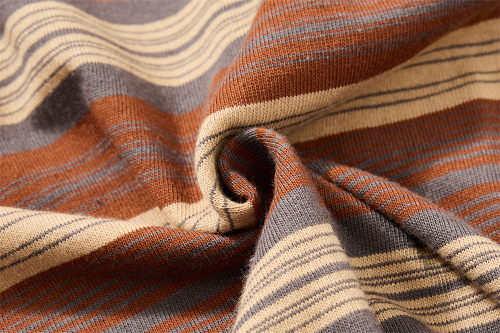Close-up of gathered striped knit fabric showing brown, gray and cream stripes