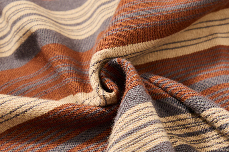 Close-up of gathered striped knit fabric showing brown, gray and cream stripes