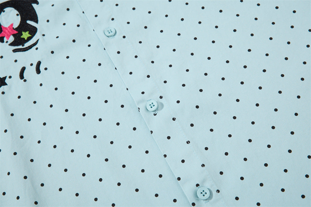Close-up of the shirt front with black polka dots and button placket