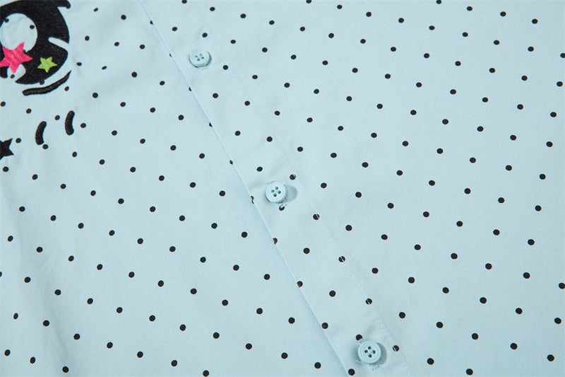 Close-up of the shirt front with black polka dots and button placket