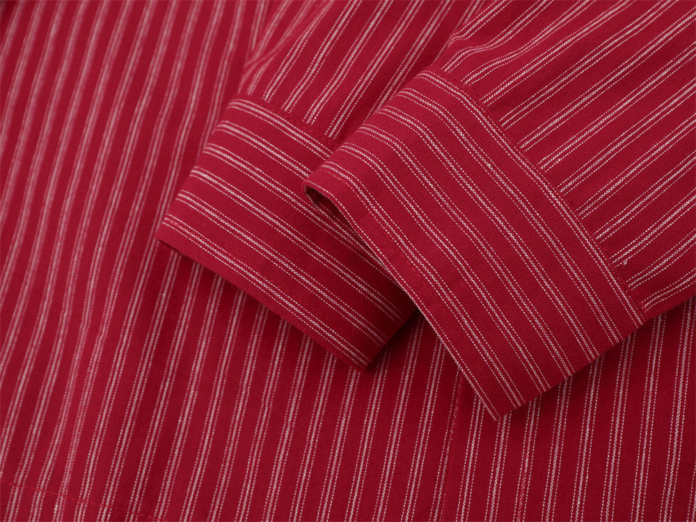 Close-up of red striped shirt sleeve cuff with button closure