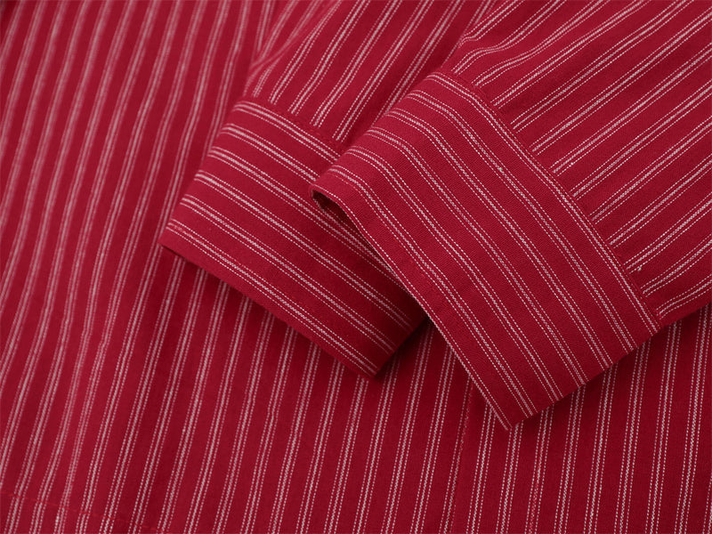 Close-up of red striped shirt sleeve cuff with button closure