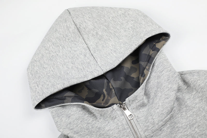 Sweat à capuche zippé avec écusson croix clouté et doublure camouflage