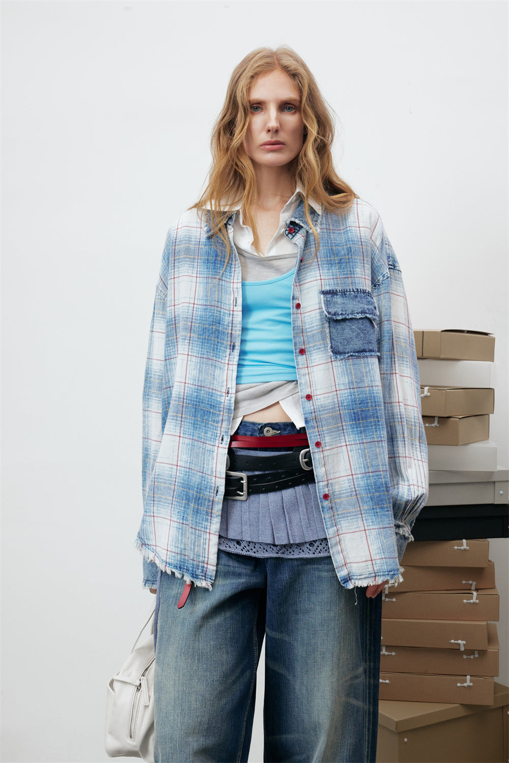 Oversized washed blue plaid long sleeve shirt with denim patch pocket and frayed hem, front and back view