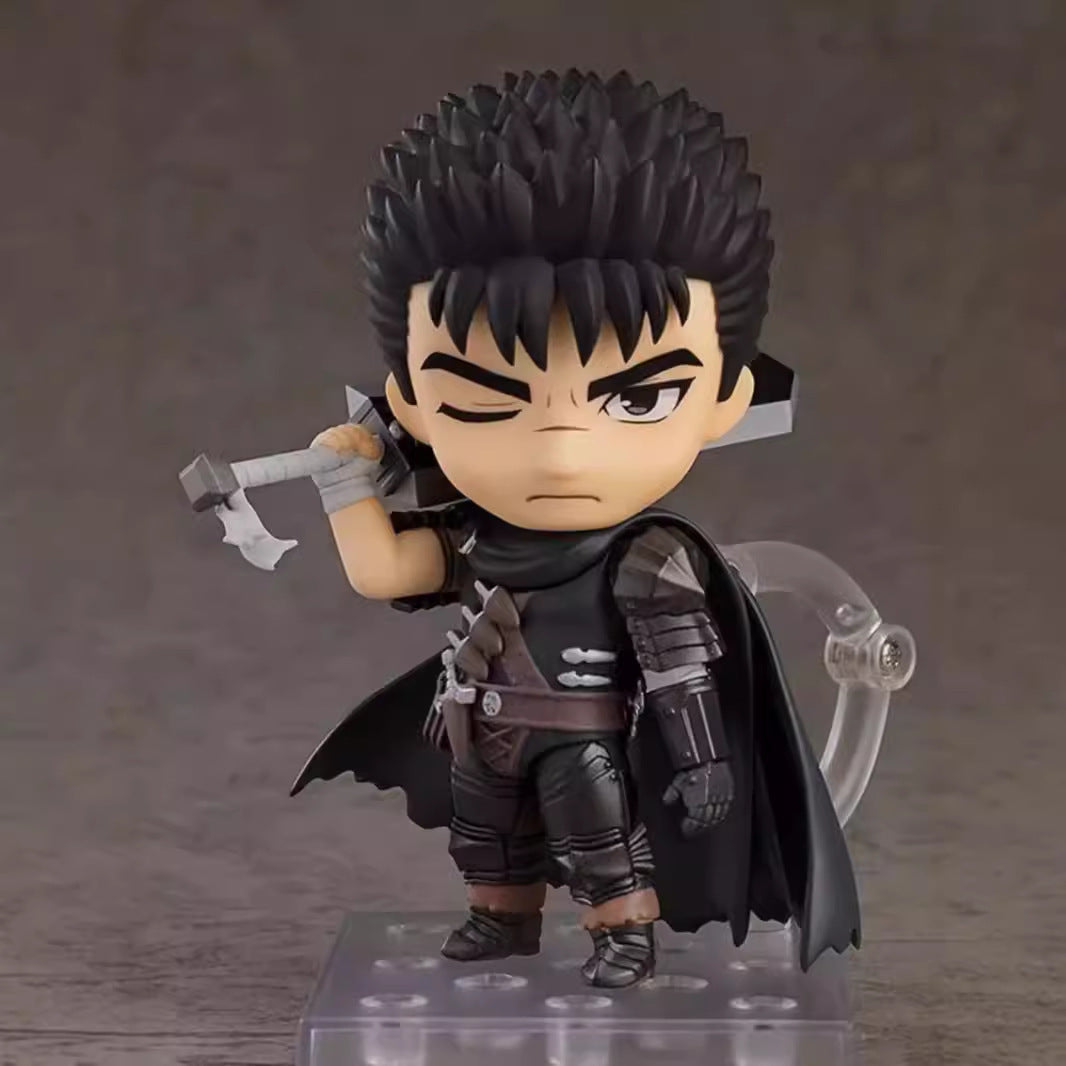 The Berserk Guts Nendoroid Action Figure is a 10 cm chibi PVC figurine with movable joints and faceplates, featuring spiky black hair, black armor, a cape, and a large sword. It stands on a clear display base with an intense expression perfect for any anime collection.