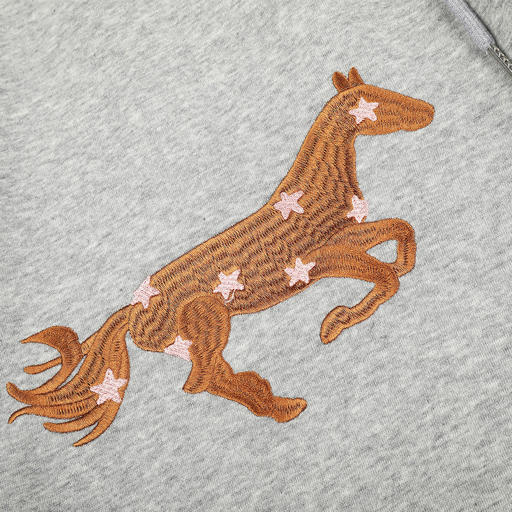 Close-up of embroidered horse graphic on heather gray sweatpants