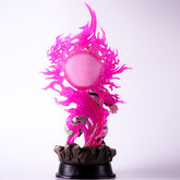 The Seakoff Majin Buu Collectible Figure from Dragon Ball Z features a 37cm character in a dynamic pose on a rock-like base, enveloped by a glowing pink aura forming a circular burst against a plain white background.