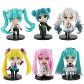 The 6-Piece Set Hatsune Miku Kimono Figures, each 9.4cm with removable heads, features distinctive chibi-style designs: top row includes teal-haired Hatsune Miku and a white-haired figure; bottom row presents yellow, pink, and more teal-haired characters in Japanese-inspired outfits.