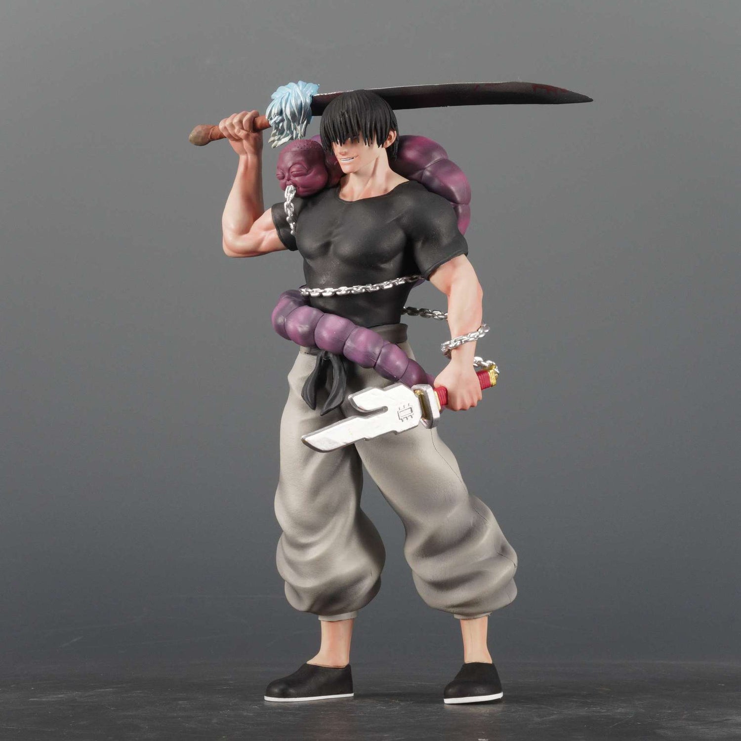 This 21 cm Jujutsu Kaisen collectible statue displays Fushiguro Toji in a dynamic pose, holding a sword over his shoulder. He wears a black shirt, gray pants, black shoes, and has a purple rope accessory at his waist against a gray backdrop.