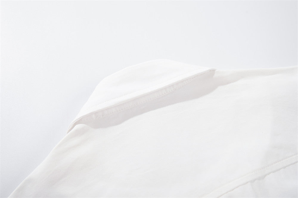 White shoulder seam and collar detail close-up
