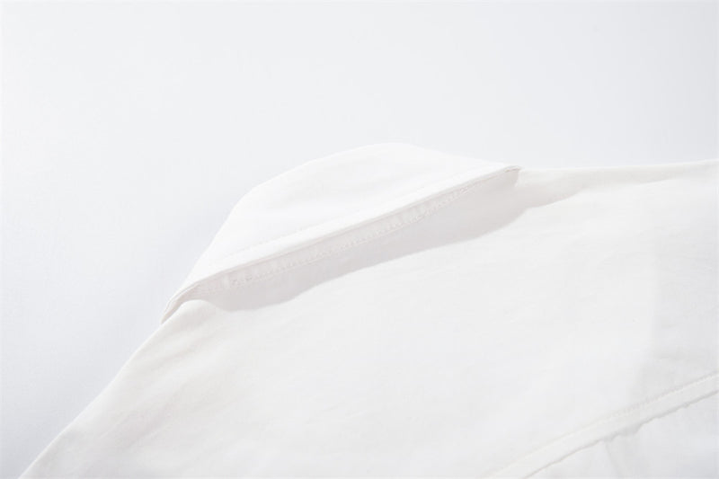 White shoulder seam and collar detail close-up