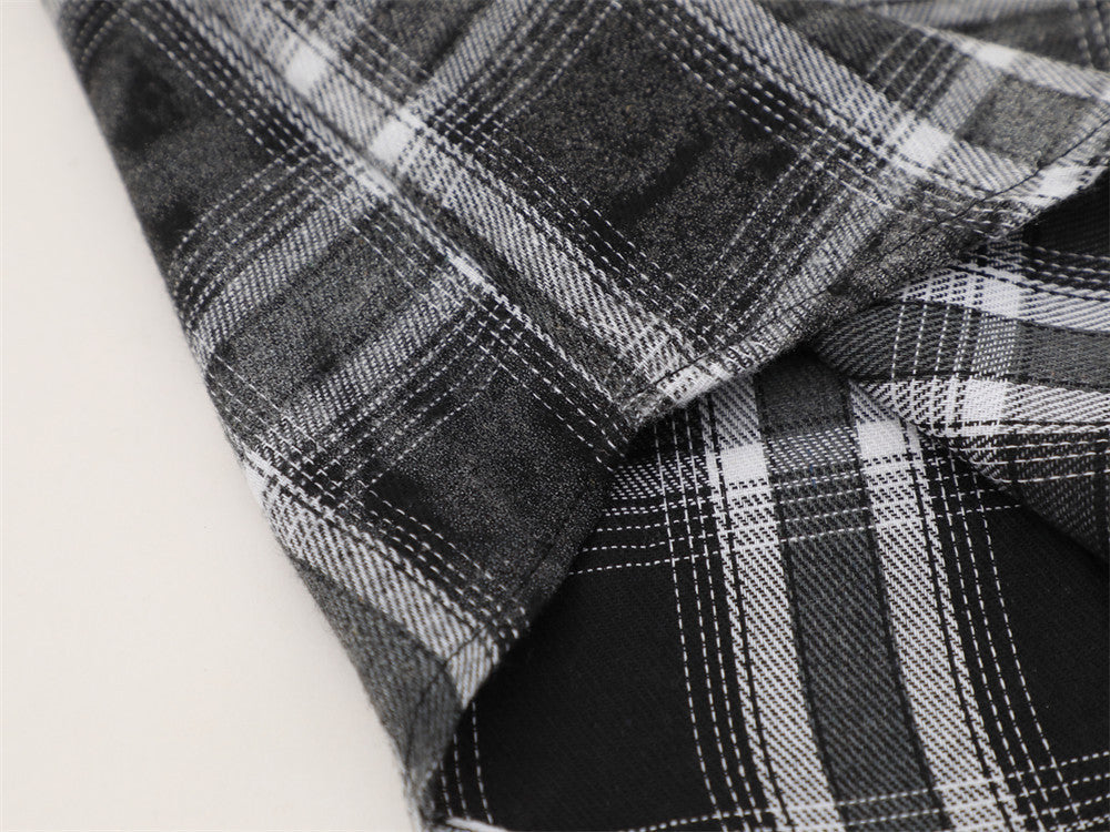 Close-up of black plaid flannel fabric folds and stitched pattern