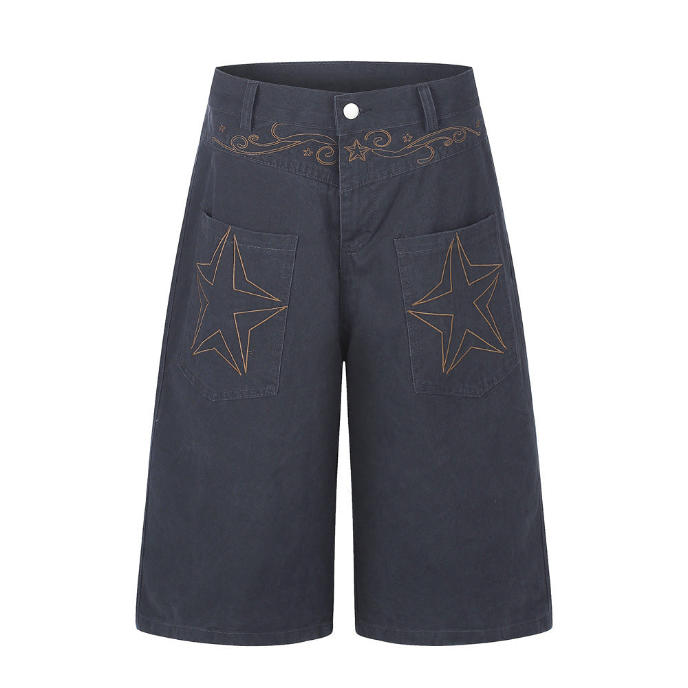 Men's wide-leg cargo shorts with large star embroidery on front patch pockets and scrollwork waistband detail in washed navy