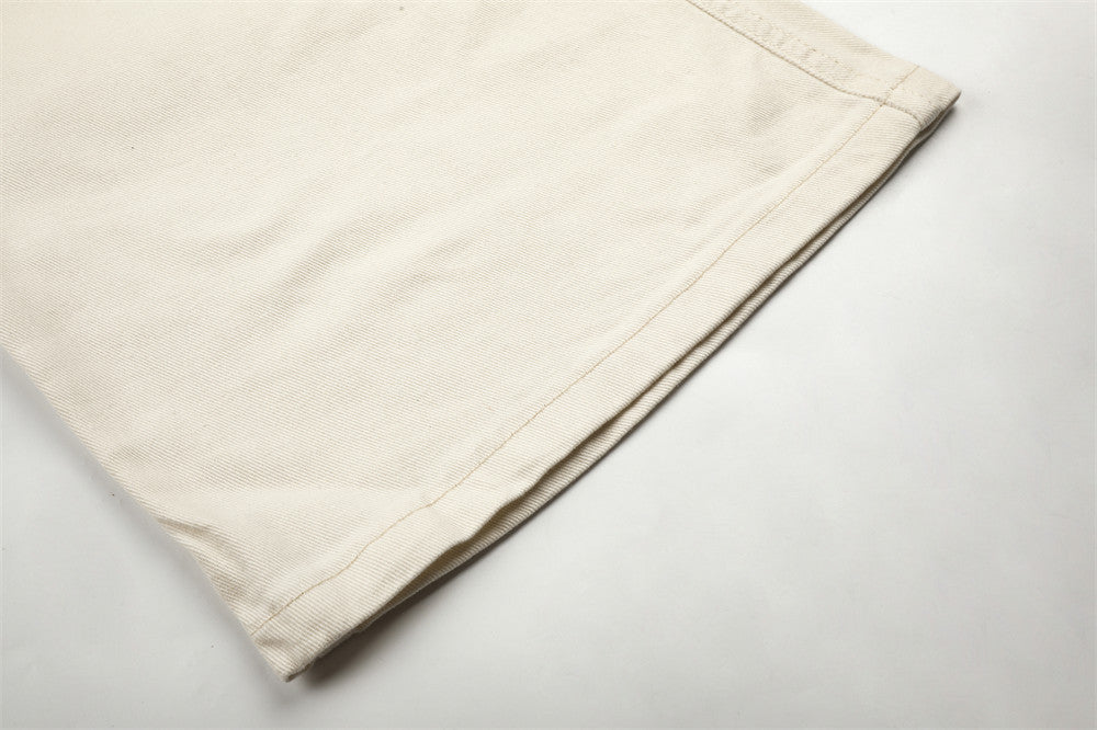 Pantalon homme coupe large orné de perles et de clous métalliques