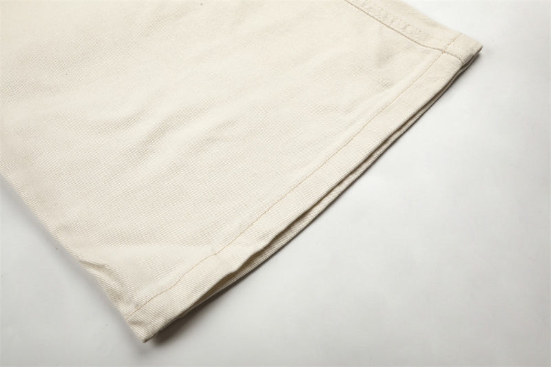 Pantalon homme coupe large orné de perles et de clous métalliques