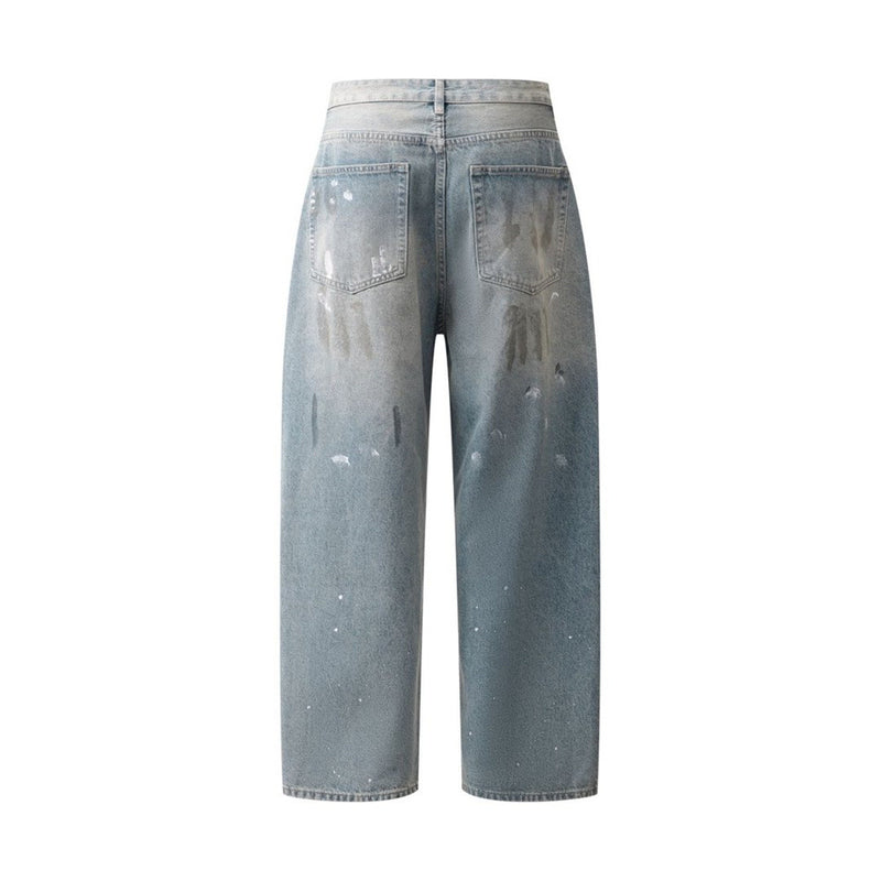 Back view of faded blue baggy jeans with paint splatter distressing and rear pockets