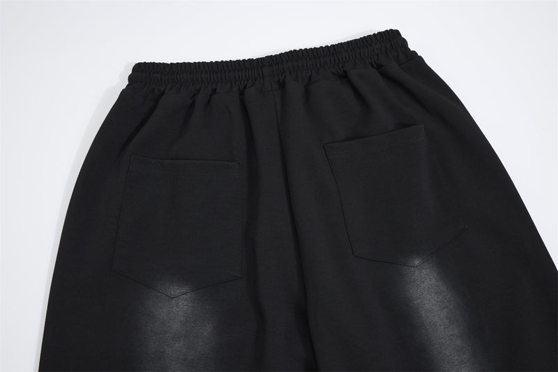 Pantalon de survêtement à jambes larges avec croix gothique et finition délavée
