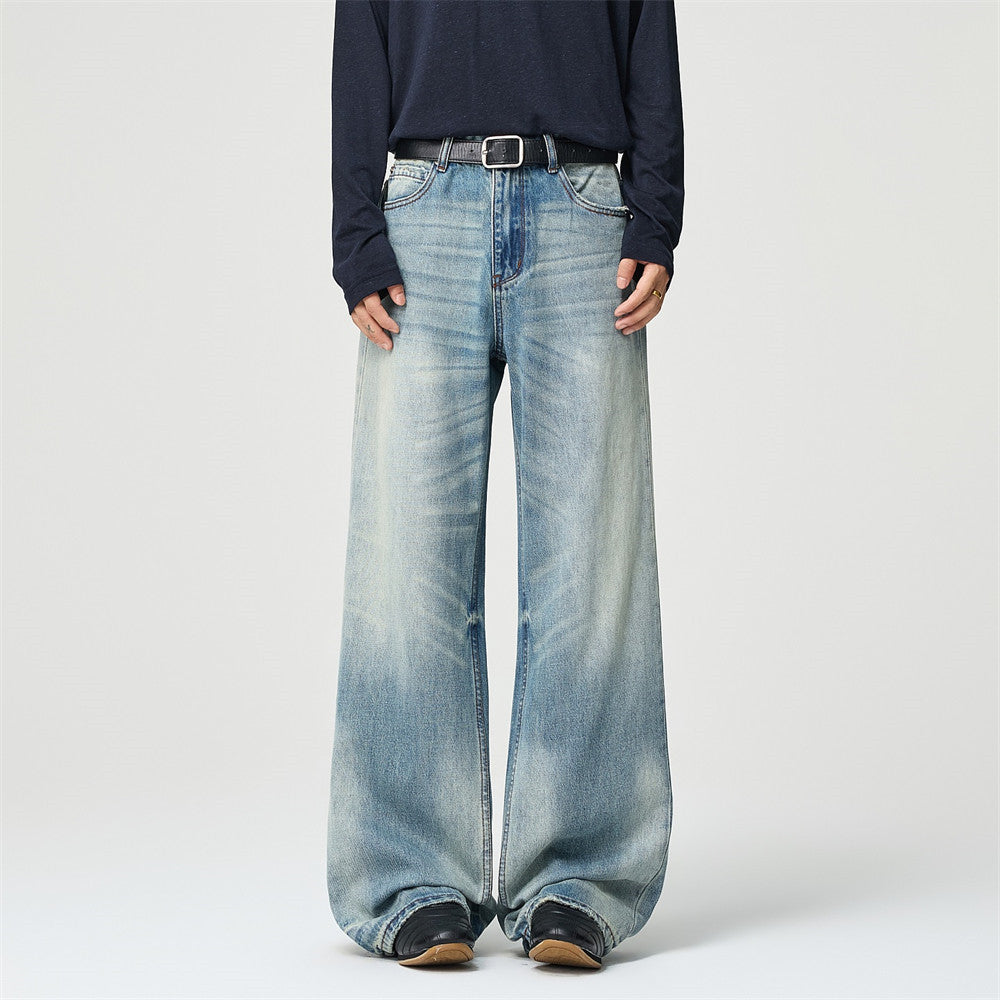 Men's light blue vintage washed baggy wide-leg jeans with whisker detailing and relaxed straight fit