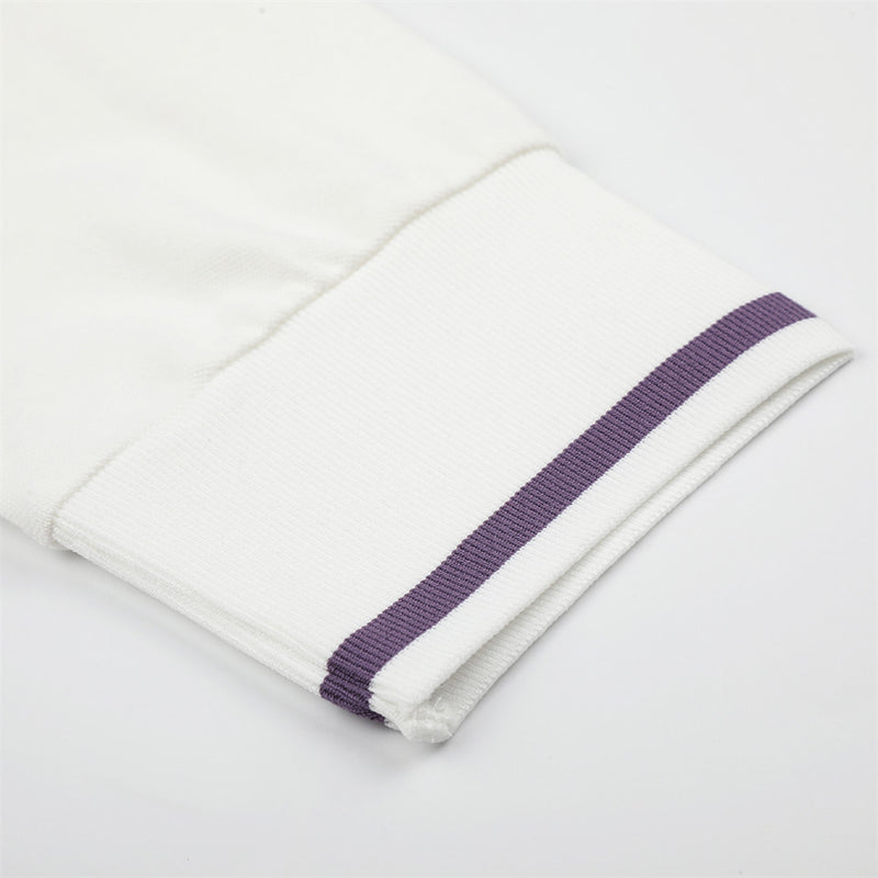 Close-up of white sleeve cuff with purple stripe trim