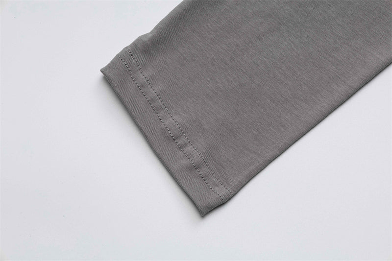 Close-up of gray T-shirt sleeve hem with double-stitched edge
