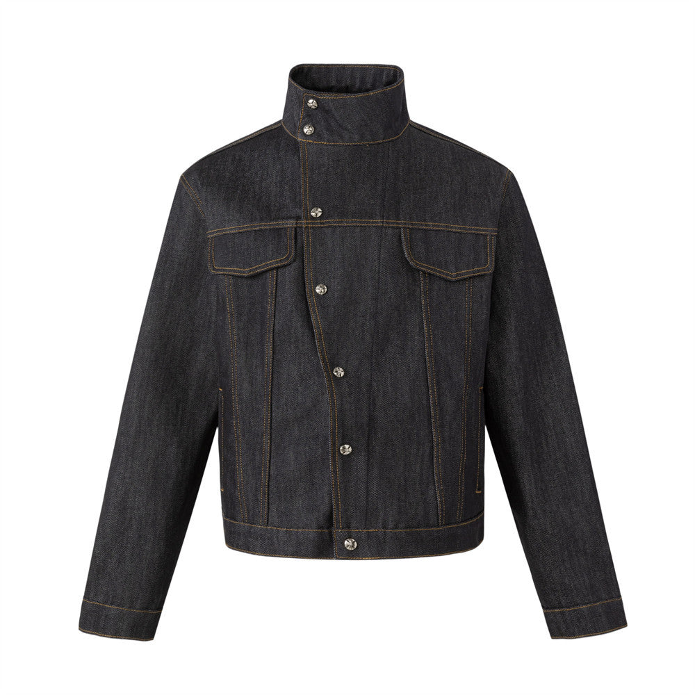 Men's black raw denim jacket with stand collar, asymmetric snap button placket, and contrast amber topstitching – front and b