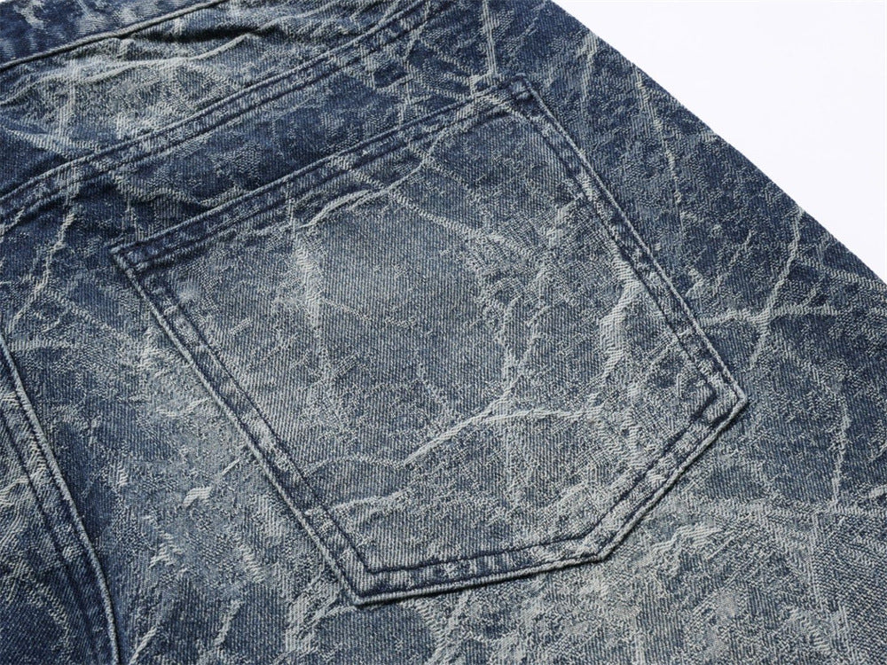 Close-up of back pocket on faded blue distressed denim jeans