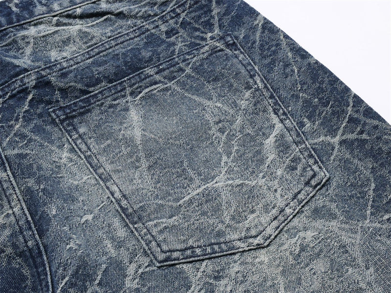 Close-up of back pocket on faded blue distressed denim jeans
