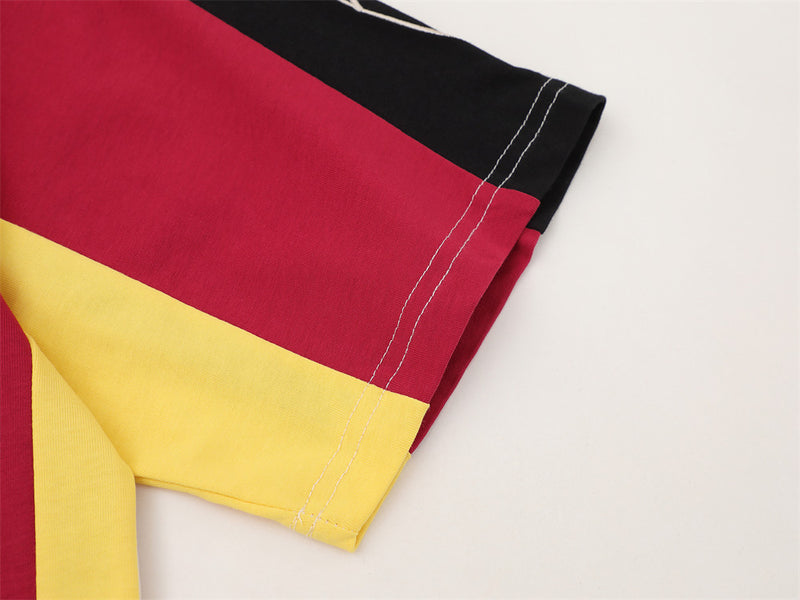 Close-up of sleeve hem with red, black, and yellow colorblock panels