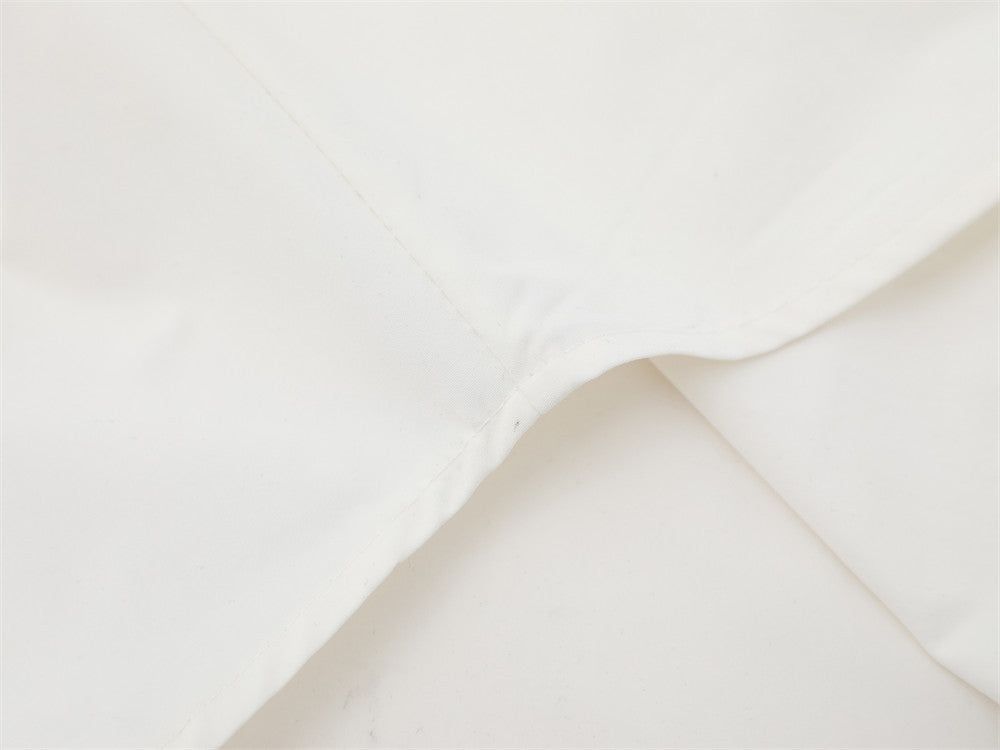 Close-up of white shirt back yoke seam and shoulder fold