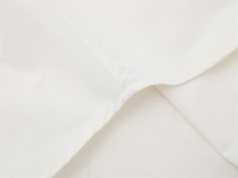 Close-up of white shirt back yoke seam and shoulder fold